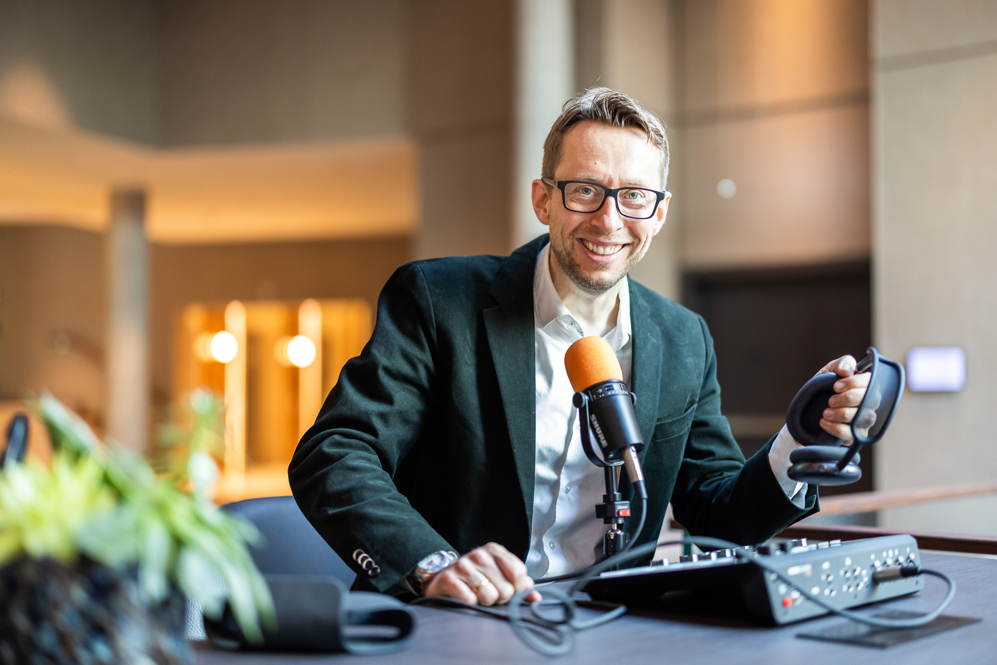 Daniel Schwenger at a podcast recording desk