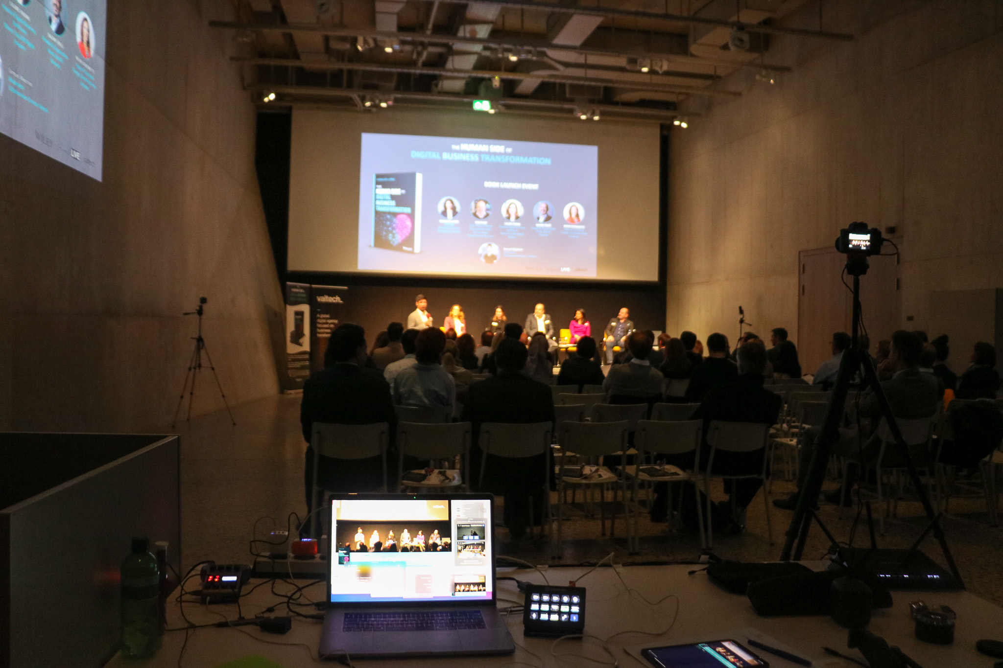Streaming desk facing a panel on stage